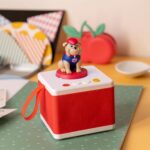 Red FABA children's storyteller with the bulldog from the English songs, on a polka-dot tablecloth