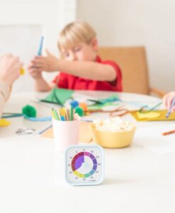 Time Timer MOD Home Edition Rainbow Wheel: niño recortando en la mesa con el reloj delante