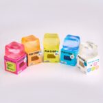 Fun Cube de J'adore: un cubo azul rodeado de las cajas de colores de la gama de la marca