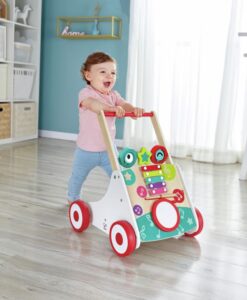 Andador musical de madera de Hape: bebé caminando por el salón agarrado al asa roja del andador