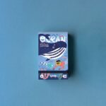 Puzzle del océano Tiny Puzzle Ocean: caja pequeña de frente con la ballena y el título Ocean